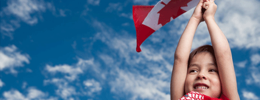 New to Canada child holding national flag